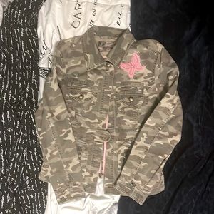 Green camo jacket with a pink butterfly or the left shoulder.